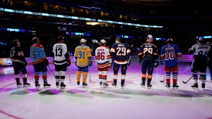 NHL hockey players stand before they are introduced before the NHL All Star Skills Showcase, Friday, Feb. 3, 2023, in Sunrise, Fla. (AP Photo/Lynne Sladky)