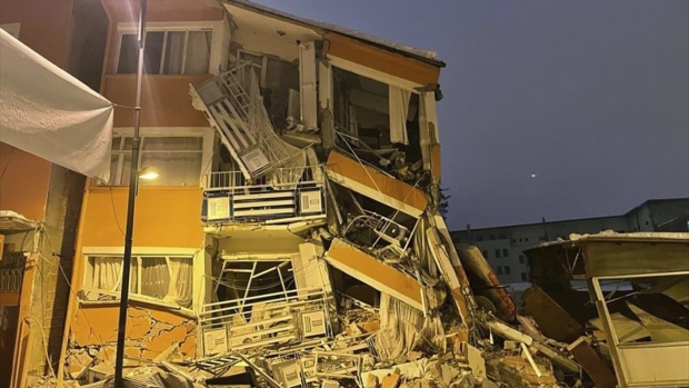 A collapsed building is seen following an earthquake in Pazarcik, in Kahramanmaras province, southern Turkey, early Monday, Feb. 6, 2023. A powerful earthquake has caused significant damage in southeast Turkey and Syria and many casualties are feared. Damage was reported across several Turkish provinces, and rescue teams were being sent from around the country. (Depo Photos via AP)