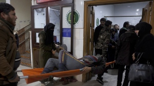 People carry a man injured in an earthquake into the al-Rahma Hospital in the town of Darkush, Idlib province, northern Syria, Monday, Feb. 6, 2023. A powerful earthquake has caused significant damage in southeast Turkey and Syria and many casualties are feared. Damage was reported across several Turkish provinces, and rescue teams were being sent from around the country. (AP Photo/Ghaith Alsayed)