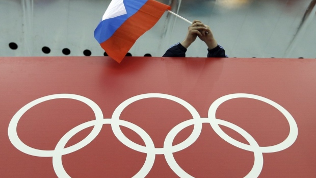 Russian flag held above the Olympic Rings