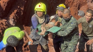 Following an overnight emergency operation, rescue workers and military carry a 1 year-old from a deep hole in the northern Thailand province of Tak, 420 kms. (260 miles) north of Bangkok, Tuesday, Feb. 7, 2023. The toddler, who is from Myanmar, fell into the 15 meter deep hole used for groundwater pipes yesterday evening. (AP Photo/Chiravuth Rungjamratratsami)