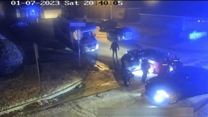 In this image from video released and partially redacted by the city of Memphis, Tenn., on Jan. 27, 2023, Tyre Nichols leans against a car after a brutal attack by five Memphis Police officers on Jan. 7, in Memphis. Officer Demetrius Haley, who is standing bent over in front of Nichols, is seen taking photographs of Nichols, which he sent to other officers and a female acquaintance. The new revelation about Haley's actions were released Tuesday, Feb. 7, in documents that provide a scathing account of what authorities called the “blatantly unprofessional” conduct of the officers involved in the fatal beating of Nichols. (City of Memphis via AP)