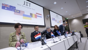 Digna van Boetzelaer, the Netherlands, Andy Kraag, the Netherlands, David McLean, Australia, Asha Hoe Soo Lian, Malaysia, Eric van der Sypt, Belgium, and Oleksandr Bannyk, Ukraine, take their seats for the Joint Investigation Team (JIT) news conference in The Hague, Netherlands, Wednesday, Feb. 8, 2023, on the results of the ongoing investigation into other parties involved in the downing of flight MH17 on 17 July 2014. The JIT investigated the crew of the Buk-TELAR, a Russian made rocket launcher, and those responsible for supplying this Russian weapon system that downed MH17. (AP Photo/Peter Dejong)