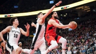 Toronto Raptors guard Fred VanVleet (23) jumps as he shoots against San Antonio Spurs forward Isaiah Roby (18) and forward Doug McDermott (17) during first half NBA basketball action in Toronto on Wednesday, February 8, 2023. THE CANADIAN PRESS/Arlyn McAdorey