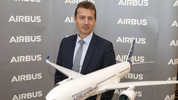 FILE - Airbus CEO Guillaume Faury poses by a replica of an Airbus A 350-900 during Airbus annual press conference in Toulouse, southwestern France, Thursday, Feb.13, 2020. The owner of Air India announced a deal Tuesday Feb.14, 2023 to buy 250 Airbus jets, including A350 wide-body planes and A320neo single-aisle planes in a deal worth billions of dollars. Air India, owned by Tata Group, is reportedly considering a similar order for Boeing as part of expansion efforts. (AP Photo/Frederic Scheiber, File)