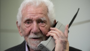 Marty Cooper, the inventor of first commercial mobile phone, poses for the press with a Motorola DynaTAC 8000x, during an interview with The Associated Press at the Mobile World Congress 2023 in Barcelona, Spain, Monday, Feb. 27, 2023. The four-day show kicks off Monday in a vast Barcelona conference center. It's the world's biggest and most influential meeting for the mobile tech industry. (AP Photo/Joan Mateu Parra)