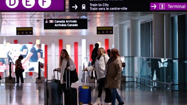 Travellers make their way through Pearson International Airport in Toronto Monday, Nov. 14, 2022. THE CANADIAN PRESS/Cole Burston