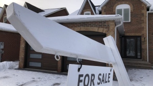 A house for sale sign is shown in front of a house in Oakville, Ont., west of Toronto, Sunday, Feb.5, 2023. THE CANADIAN PRESS/Richard Buchan