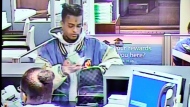 Jahseh Onfroy, 20, whose stage name was XXXTentacion, places US$50,000 he withdrew from his account in a Louis Vuitton bag at a Bank of America branch, on June 18, 2018, in a video that was shown during the murder trial of defendants Michael Boatwright, Trayvon Newsome and Dedrick Williams at the Broward County Courthouse in Fort Lauderdale, Fla., Tuesday, Feb. 7, 2023. (Amy Beth Bennett/South Florida Sun-Sentinel via AP, Pool) 