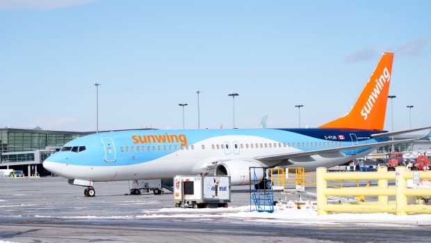 A Sunwing aircraft is parked at Montreal Trudeau airport in Montreal on Wednesday, March 2, 2022. The WestJet Group has announced a deal to buy Sunwing Airlines Inc. THE CANADIAN PRESS/Paul Chiasson 