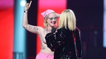 Avril Lavigne confronts a topless protester as she presents during the Junos Monday, March 13, 2023. THE CANADIAN PRESS/Timothy Matwey