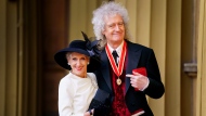 Sir Brian May, musician, songwriter and animal Welfare Advocate, right, poses with her wife Anita Dobson after being made a Knight Bachelor by King Charles III during an investiture ceremony at Buckingham Palace, London, Tuesday March 14, 2023. (Victoria Jones/Pool via AP)