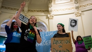 Sarah Bentley, second from left, leads songs at an International Women's Day Sit-In for Abortion Rights in the Texas state Capitol Rotunda, Wednesday, March 8, 2023, in Austin, Texas. A federal judge in Texas overseeing a high-stakes case that could threaten access to medication abortion told lawyers not to publicize upcoming arguments in the lawsuit and that “less advertisement of this hearing is better,” according to a transcript of the meeting released Tuesday, March 14. (Sara Diggins/Austin American-Statesman via AP, File)