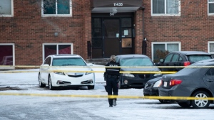 Police investigate the scene where two officers were shot and killed on duty in Edmonton on Thursday, March 16, 2023. THE CANADIAN PRESS/Jason Franson 