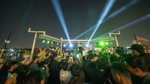 Youths gather along the Tigris River for a concert by rap artist Khalifa OG in Baghdad, Iraq, Saturday Feb. 25, 2023. In his music, he sings about the difficulties of finding work and satirizes authority, but is not blatantly political. (AP Photo/Jerome Delay)