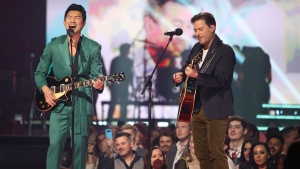 Simu Liu, left, and Ryan Peake of Nickelback perform during the Juno Awards in Edmonton on Monday, March 13, 2023. THE CANADIAN PRESS/Timothy Matwey
