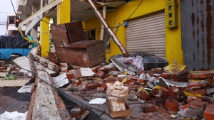 Debris from collapsed homes are scattered on a street after an earthquake shook Machala, Ecuador, Saturday, March 18, 2023. The U.S. Geological Survey reported an earthquake with a magnitude of about 6.8 that was centered just off the Pacific Coast, about 50 miles (80 kilometers) south of Guayaquil. (AP Photo/Cesar Munoz)