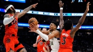 Milwaukee Bucks' Giannis Antetokounmpo is fouled as he drives to the basket against Toronto Raptors' Gary Trent Jr. (33), O.G. Anunoby (3), Jakob Poeltl (19) and Fred VanVleet during the second half of an NBA basketball game Sunday, March 19, 2023, in Milwaukee. (AP Photo/Aaron Gash)