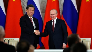 Russian President Vladimir Putin, right, and Chinese President Xi Jinping shake hands after speaking to the media during a signing ceremony following their talks at The Grand Kremlin Palace, in Moscow, Russia, Tuesday, March 21, 2023. (Mikhail Tereshchenko, Sputnik, Kremlin Pool Photo via AP)