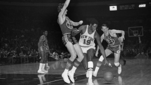 FILE - New York Knicks Willis Reed (19) drives against San Francisco Warrior Clyde Lee (43) during an NBA game at Madison Square Garden in New York, March 4, 1970. At right is San Francisco Warrior Jeff Mullins (23). Willis Reed, who dramatically emerged from the locker room minutes before Game 7 of the 1970 NBA Finals to spark the New York Knicks to their first championship and create one of sportsâ€™ most enduring examples of playing through pain, died Tuesday, March 21, 2023. He was 80. Reed's death was announced by the National Basketball Retired Players Association, which confirmed it through his family. (AP Photo/John Lent, File)