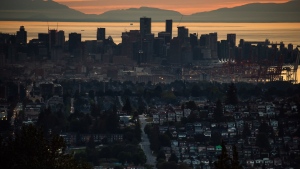 The downtown Vancouver skyline and port are seen at sunset along with houses lining a hillside in Burnaby, B.C., on Monday, July 11, 2022. Realtors are expecting Canadians to move off the housing market's sidelines this spring. THE CANADIAN PRESS/Darryl Dyck