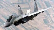FILE - A Yugoslav airforce Mig-29 fighter flies over Belgrade, on June 1998, during patrol duty. Slovakia was offered 12 new military helicopters by the United States as compensation for the MiG-29 fighter jets the country decided to give to Ukraine, Defense Minister Jaroslav Nad said on Wednesday, March 22, 2023. (AP PHOTO/Sasa Radic)
