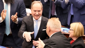Ontario Finance Minister Peter Bethlenfalvy (left) shakes hands with Premier Doug Ford after tabling the provincial budget as Health Minister Sylvia Jones looks on at the legislature at Queen's Park in Toronto on Thursday, March 23, 2023. THE CANADIAN PRESS/Frank Gunn