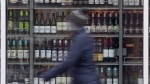 A person walks past shelves of bottles of alcohol on display at an LCBO in Ottawa, Thursday, March 19, 2020. Canada's restaurant industry is bracing for the biggest jump in the country's alcohol excise duty in more than 40 years, spurring warnings the tax hike could force some bars and restaurants out of business. THE CANADIAN PRESS/Adrian Wyld