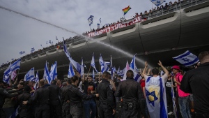Israeli police use water cannon to disperse Israelis protest against plans by Prime Minister Benjamin Netanyahu's government to overhaul the judicial system in Tel Aviv, Israel, Thursday, March 23, 2023. (AP Photo/Ohad Zwigenberg)