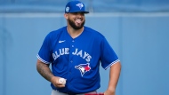 Toronto Blue Jays starting pitcher Alek Manoah laughs as he warms up his arm during baseball spring training in Dunedin, Fla., on Friday, February 17, 2023. THE CANADIAN PRESS/Nathan Denette