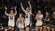 Iowa forward Monika Czinano (25), guard Kate Martin (20), forward McKenna Warnock (14) and guard Caitlin Clark (22) celebrate after a Sweet 16 college basketball game of the NCAA tournament against Colorado, Friday, March 24, 2023, in Seattle. (AP Photo/Stephen Brashear)
