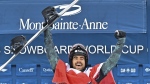 Eliot Grondin of Sainte-Marie Que., celebrates his victory in the men’s finals, at the FIS snowboard cross world cup event at Mont-Sainte-Anne resort, in Beaupre, Que., Saturday, March 25, 2023. THE CANADIAN PRESS/Jacques Boissinot