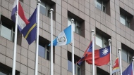 A pole, third left, where Honduras national flag used to fly is vacant outside the Diplomatic Quarter building in Taipei, Taiwan, Sunday, March 26, 2023. Honduras formed diplomatic ties with China on Sunday after breaking off relations with Taiwan, which is now recognized by only 13 sovereign states, including Vatican City. (AP Photo/Chiang Ying-ying)