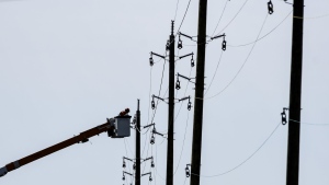 A utility worker works from a bucket lift along after a storm caused damage to the city’s power distribution network, in Ottawa, on Tuesday, May 24, 2022. Tens of thousands of customers remain without power in Ontario after strong winds hit most of southern and eastern Ontario on Saturday. THE CANADIAN PRESS/Justin Tang