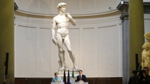 FILE - German Chancellor Angela Merkel, left, and Italian Prime Minister Matteo Renzi speak during a press conference in front of Michelangelo's "David statue" after their bilateral summit in Florence, Italy, on Jan. 23, 2015. The head of Florence’s Galleria del’Accademia on Sunday March 26, 2023 invited the parents and students of a Florida charter school to visit and see Michelangelo’s “David,” after the school principal was forced to resign following parental complaints that an image of the nude Renaissance masterpiece was shown to a sixth-grade art class. (AP Photo/Antonio Calanni, File)
