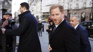 Britain's Prince Harry, center right, arrives at the Royal Courts Of Justice, in London, Monday, March 27, 2023.  (Jordan Pettitt/PA Wire/PA via AP)