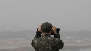 A South Korean army soldier watches the North Korea side from the Unification Observation Post in Paju, South Korea, near the border with North Korea, Friday, March 24, 2023. North Korea said Friday its cruise missile launches this week were part of nuclear attack simulations that also involved a detonation by a purported underwater drone as leader Kim Jong Un vowed to make his rivals "plunge into despair." (AP Photo/Ahn Young-joon)