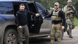 Ukraine's President Volodymyr Zelenskyy gets out of a car as he arrives for a visit to Zaporizhzhia, Ukraine, Monday March 27, 2023. (AP Photo/Efrem Lukatsky)
