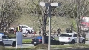 In this image from video provided by Jozen Reodica, law enforcement officers lead children away from the scene of a shooting at The Covenant School, a private Christian school in Nashville, Tenn., on Monday March 27, 2023. (Jozen Reodica via AP)