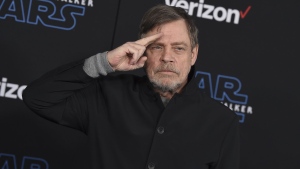 Mark Hamill salutes as he arrives at the world premiere of "Star Wars: The Rise of Skywalker" in Los Angeles on Dec. 16, 2019. (Jordan Strauss/Invision/AP, File)