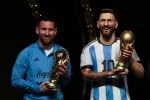 Argentina's soccer star Lionel Messi holds a replica of the FIFA World Cup trophy next to a statue of himself during a ceremony at the CONMEBOL headquarters in Asuncion, Monday, March 27, 2023. CONMEBOL authorities held a ceremony to honor the Argentine squad after they won the World Cup, prior to the draw for the group stage of Libertadores and Sudamericana tournaments. (AP Photo/Jorge Saenz)