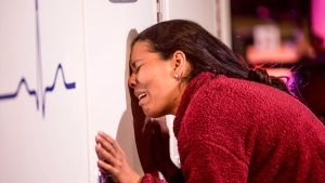 A migrant cries leaning on an ambulance as a person she knows is attended by medics after a fire broke out at the Mexican Immigration Detention center in Juarez on Monday, March, 27, 2023. A fire in a dormitory at a Mexican immigration detention center near the U.S. border left more than three dozen migrants dead. It was one of the deadliest incidents ever at an immigration lockup in the country. (Omar Ornelas/The El Paso Times via AP)