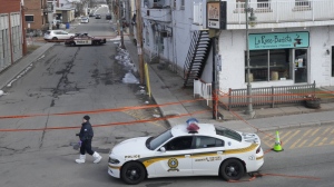 Police tape cordons off the scene after a Quebec provincial police officer was killed while trying to arrest a man in Louiseville, Que., Tuesday, March 28, 2023. THE CANADIAN PRESS/Ryan Remiorz