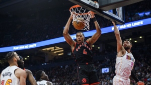 Toronto Raptors forward Scottie Barnes (4) dunks the ball while Miami Heat guard Max Strus (31) defends during first half NBA basketball action, in Toronto on Tuesday, March 28, 2023. THE CANADIAN PRESS/Christopher Katsarov