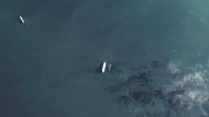 In this satellite photo by Planet Labs PBC, the oil tankers the Oceania, center left, and the Abyss, center right, are seen in the Malacca Strait between Indonesia and Malaysia on Tuesday, March 28, 2023. The Oceania, owned by a major U.S.-traded transportation company, appears to be taking on Iranian crude oil in a key Asian maritime strait in violation of American sanctions, an advocacy group alleges. The firm allegedly involved, Euronav, said Wednesday, March 29, 2023, it will "take appropriate action when necessary." (Planet Labs PBC via AP)