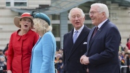German President Frank-Walter Steinmeier, right, his wife Elke Buedenbender, left, and Britain's King Charles and Camilla, the Queen Consort attend a welcome ceremony, in Berlin, Germany, March 29, 2023. (Wolfgang Rattay/Pool via AP)