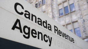 A sign outside the Canada Revenue Agency is seen Monday May 10, 2021 in Ottawa. The Canada Revenue Agency will pilot a new automatic tax filing system next year to help vulnerable Canadians who don't file their taxes get the benefits to which they're entitled. THE CANADIAN PRESS/Adrian Wyld