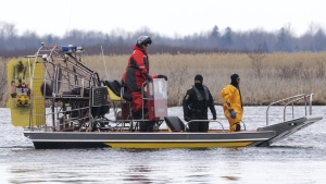 Searchers look for victims Friday, March 31, 2023. The bodies of eight migrants were pulled from the St. Lawrence River in Akwesasne, Que. THE CANADIAN PRESS/Ryan Remiorz