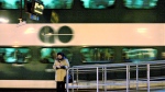 A woman reads a book as a GO commuter train pulls away from the platform at Toronto's Union Station, March 4, 2008./THE CANADIAN PRESS