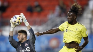 Toronto FC keeper Alex Bono (25) grabs the ball beside Nashville SC forward CJ Sapong (17) during MLS soccer action in Toronto, Saturday, September 18, 2021. Toronto FC has traded centre back Lukas MacNaughton and up to US$200,000 in general allocation money to Nashville SC for Sapong. THE CANADIAN PRESS/Cole Burston